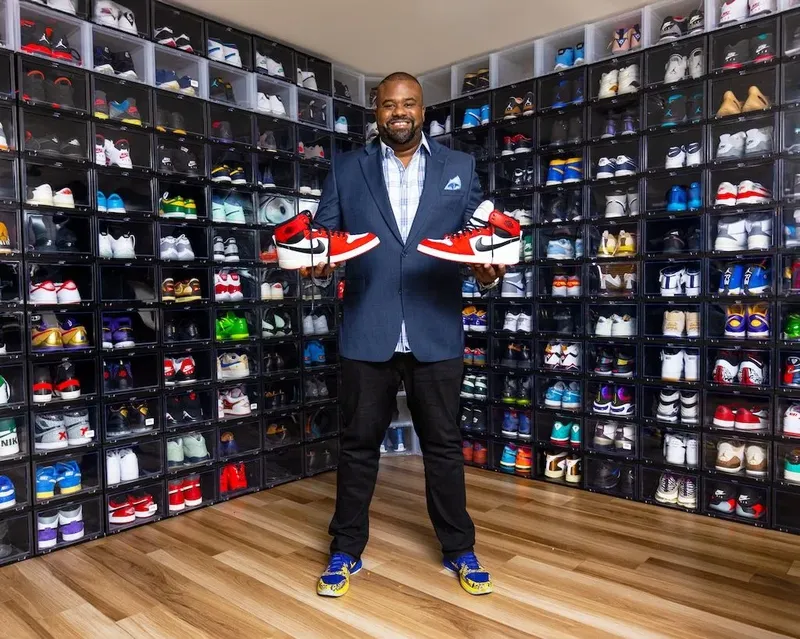 Personal branding portrait of a man with his sneaker collection